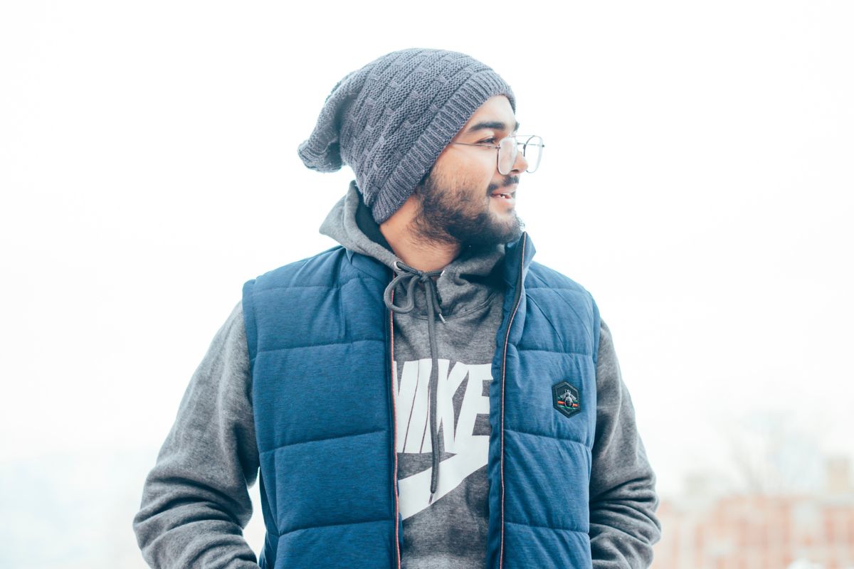 Man in gray knit cap and blue puffer jacket.